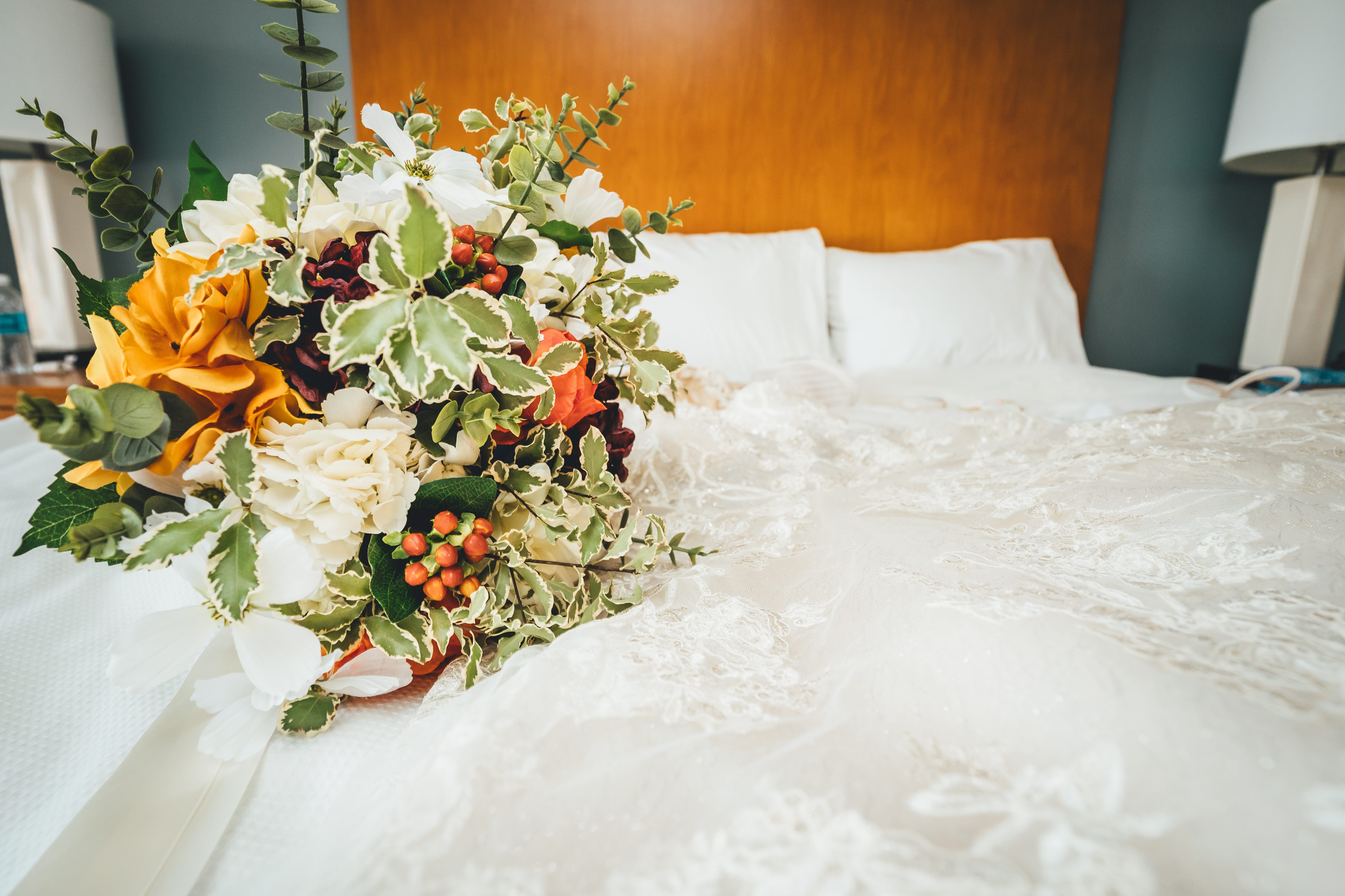 The bridal bouquet resting on the lace wedding dress