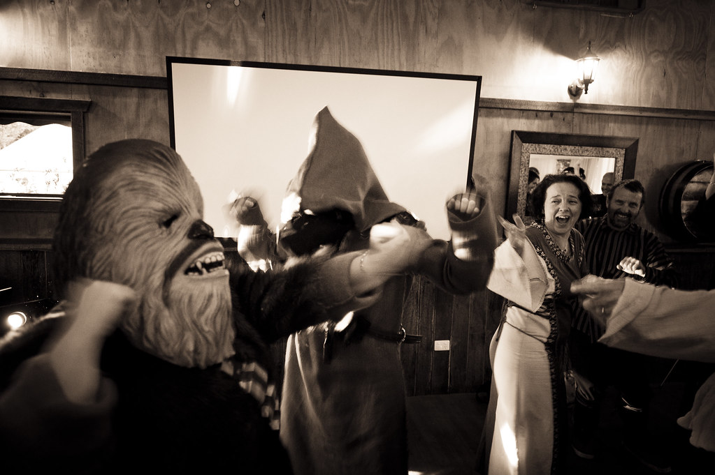 A guest in a Chewbacca costume dances at a Star Wars wedding reception
